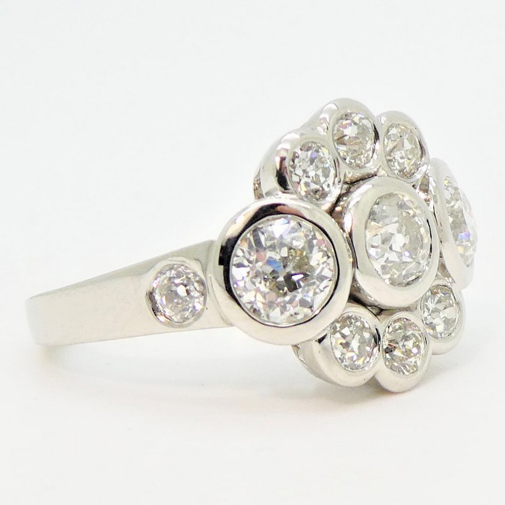 Diamond rub-over cluster engagement ring in platinum