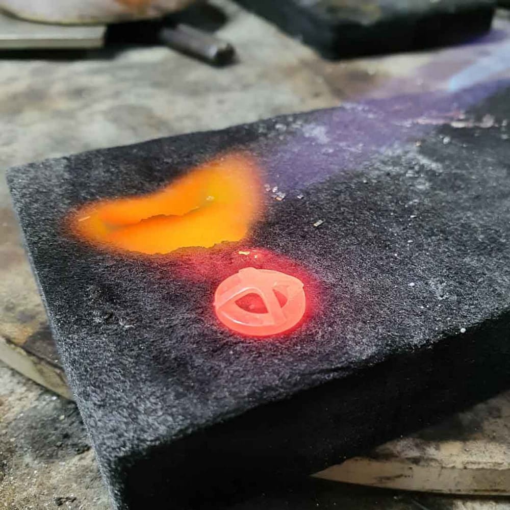 Making a ring under the flame being heated to allow solder to flow