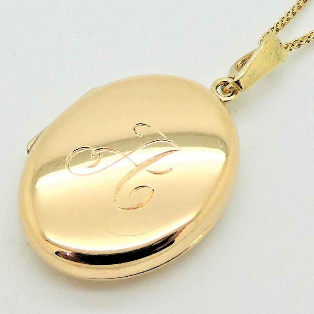 Gold locket engraved initial