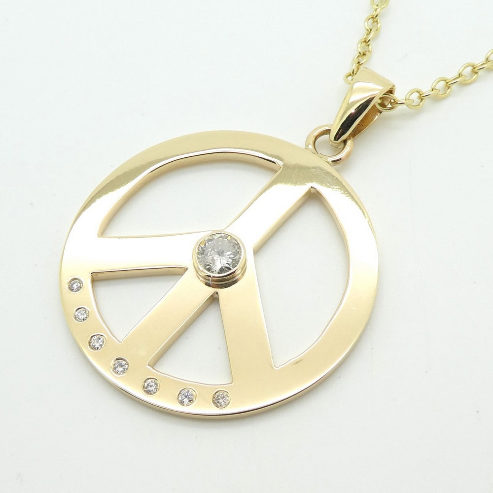 Yellow gold and diamond peace pendant