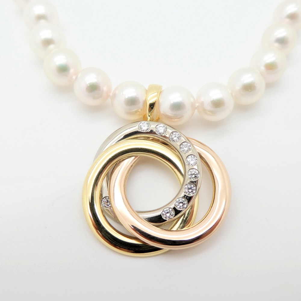 Diamond set triple ring pendant yellow white and rose gold
