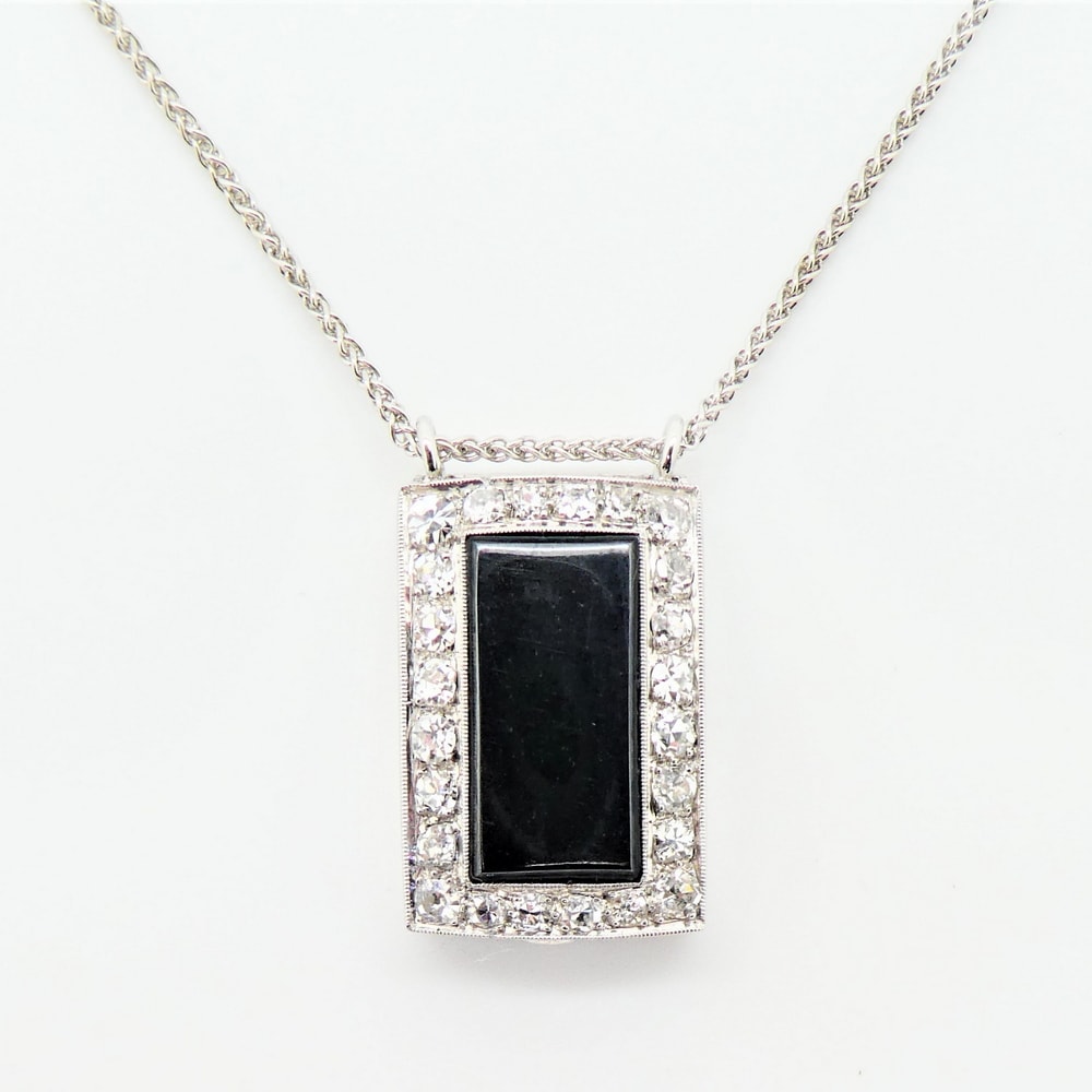 Diamond set watch case with black onyx pendant