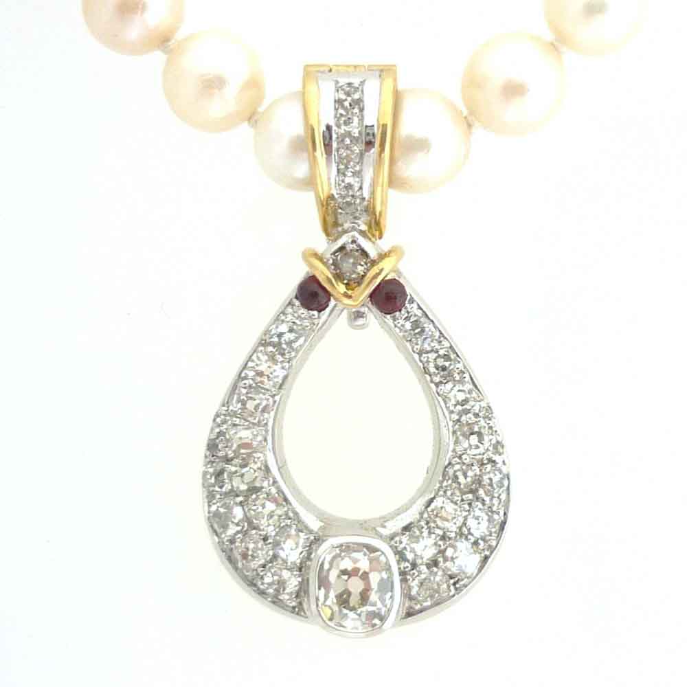 Diamond pendant with ruby and yellow gold detail