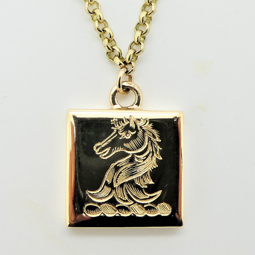 Gold pendant engraved family crest