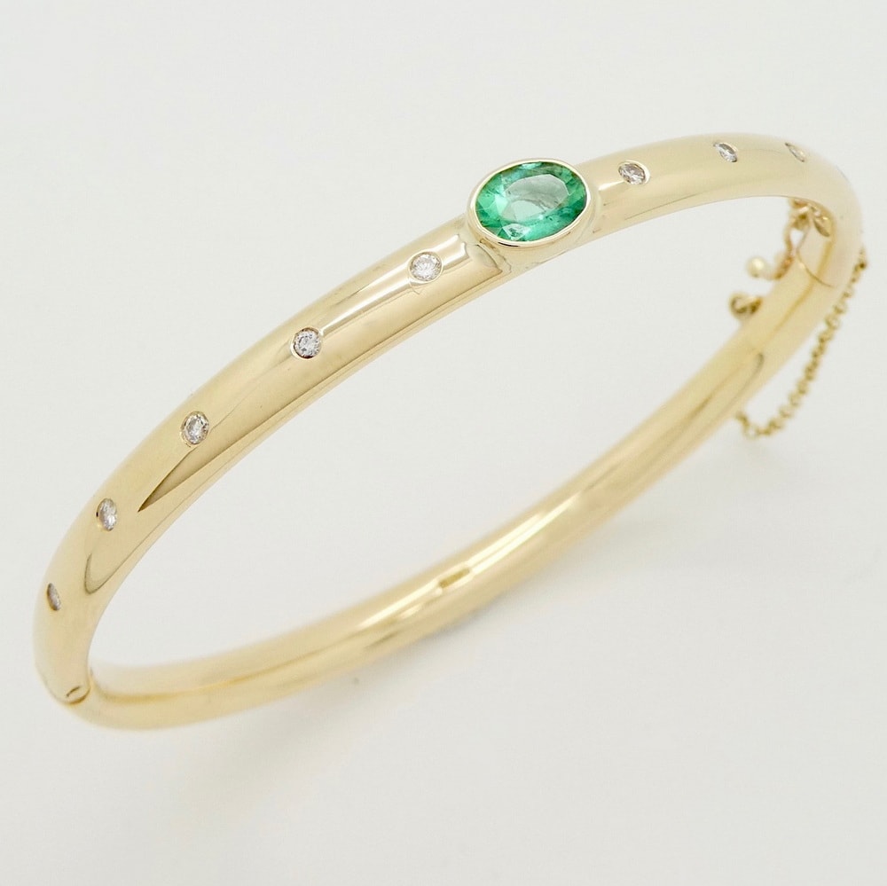 Emerald and diamond yellow gold bangle